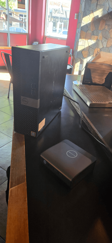 BOSGAME E1 Mini PC installed and mounted inside a locked network security cabinet