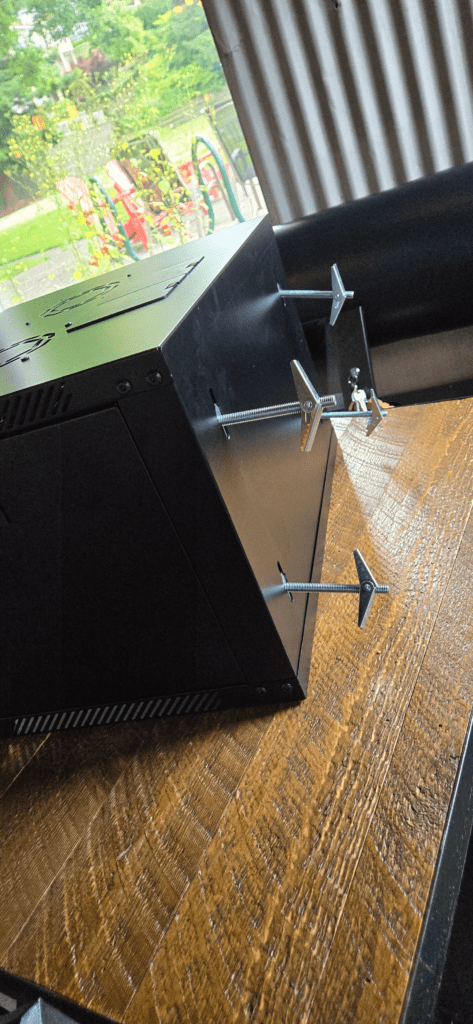 Close-up detail of cabinet network components during garage pre-assembly