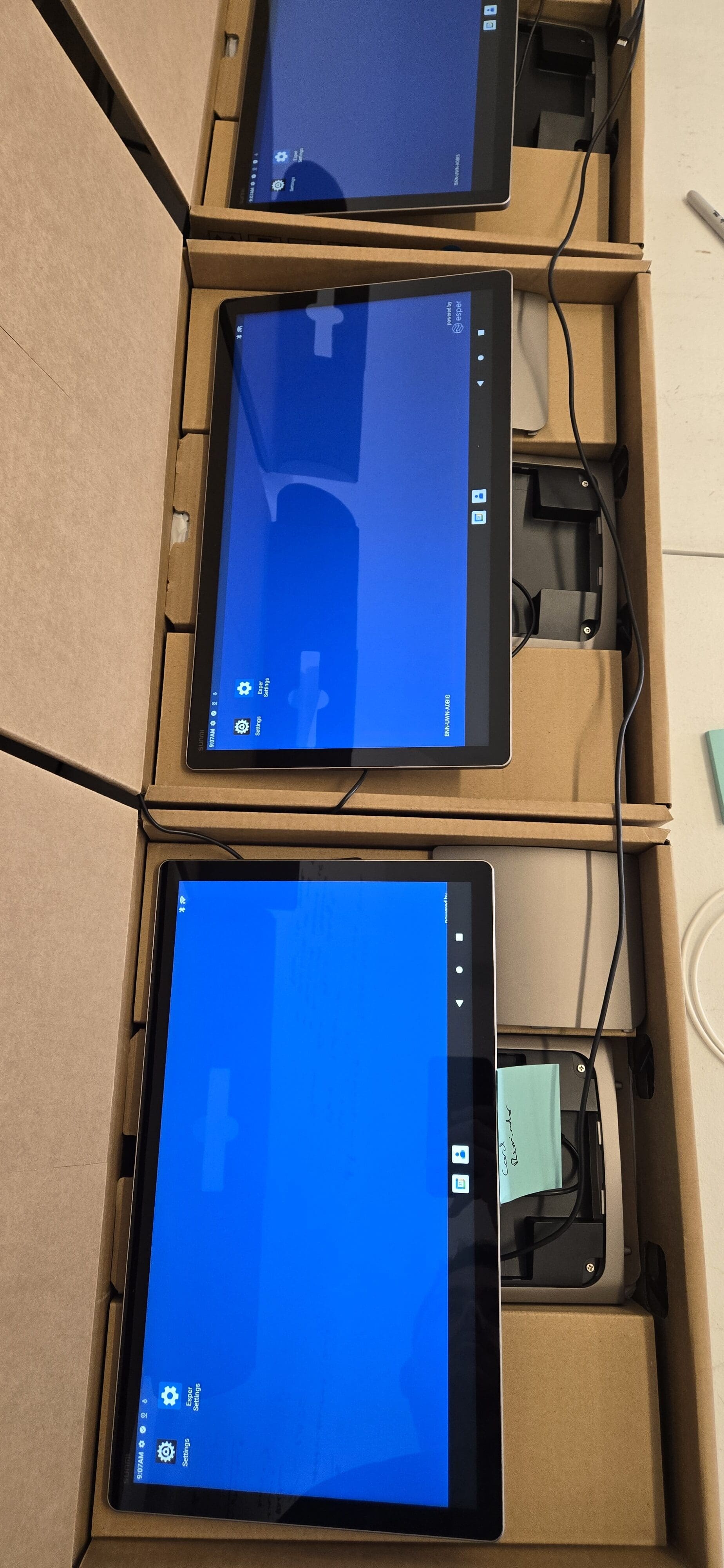 Cart loaded with D3 Pro POS boxes being transported via elevator to the staging area