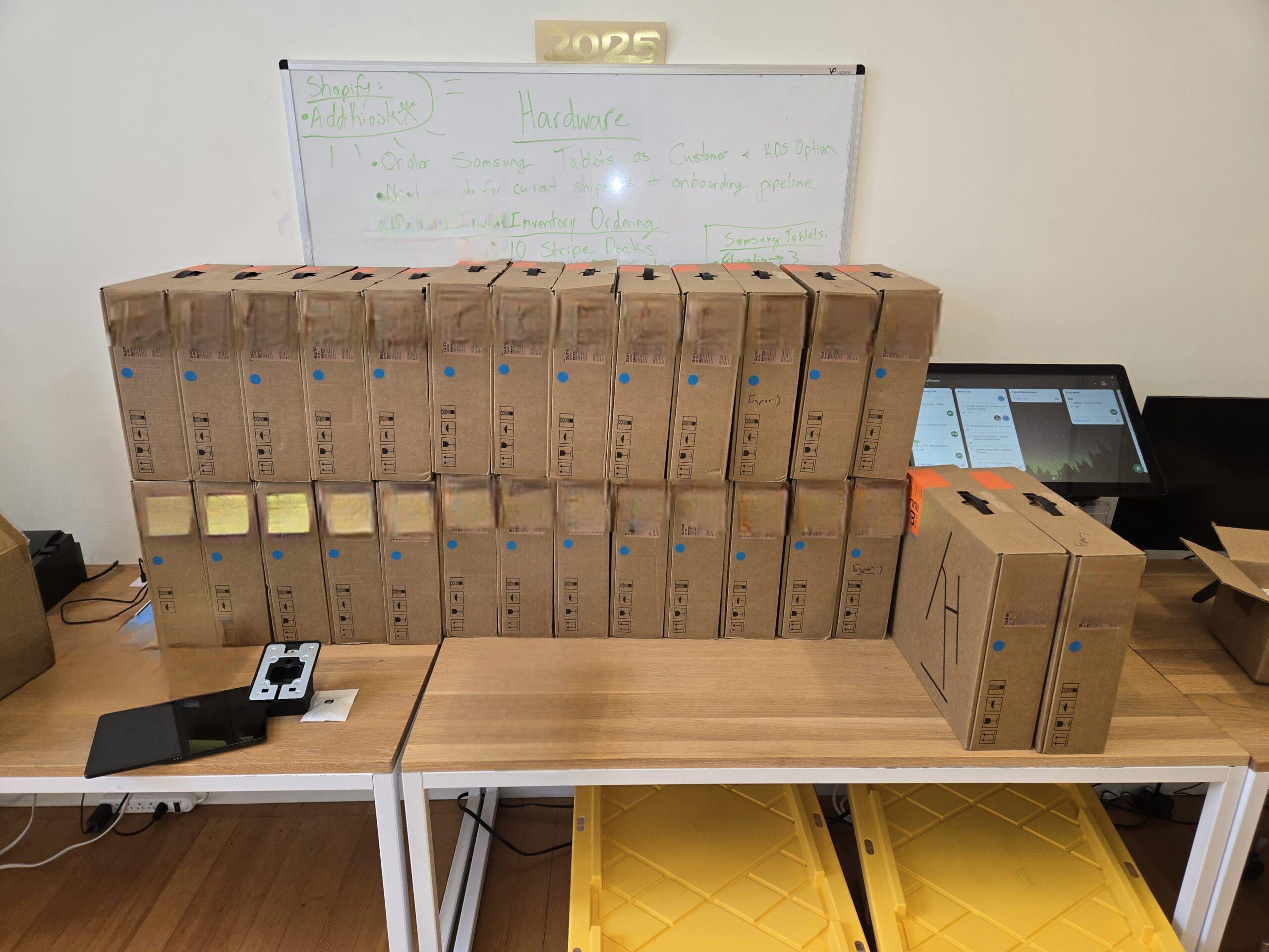 All Samsung tablets labeled with unique device IDs and arranged ready to be packed for shipping
